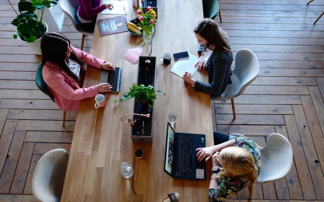 top down photo of a long desk in a co-working space - what soft skills should you look for in your staff